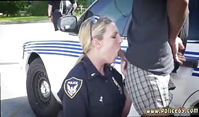 A policewoman is pulling a cock in the open air