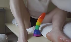 The amateur jerks a rainbow dick