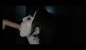 Black-haired babe sucks a rubber dick