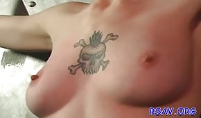 A tattoo between the tits of a fierce contestant